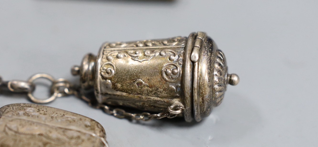 A 19th century plated five chain chatelaine, with a thimble holder, a silver Vesta and a medallion, a note book and two oval metal panels